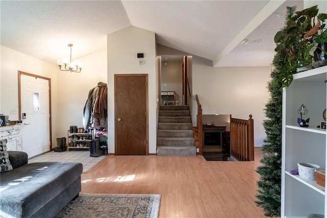 interior space featuring light hardwood / wood-style flooring, a chandelier, and lofted ceiling