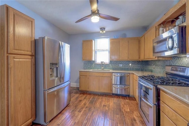 kitchen featuring sink, stainless steel appliances, dark hardwood / wood-style flooring, ceiling fan, and light brown cabinets