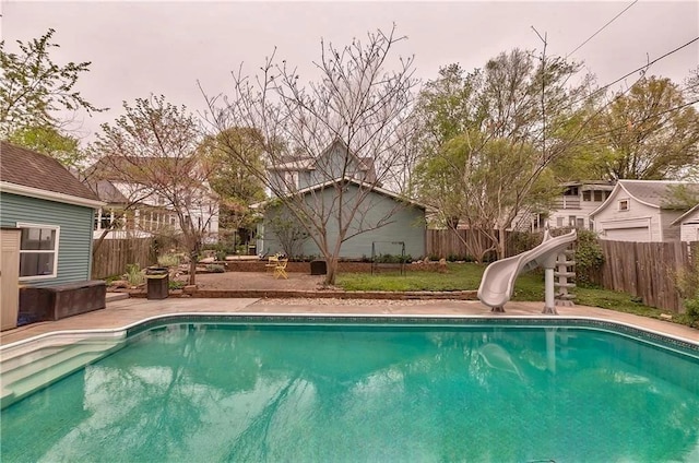 view of swimming pool with a water slide