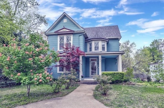 victorian-style house featuring a front lawn