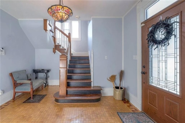 foyer entrance featuring ornamental molding