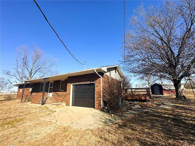 exterior space featuring a garage and a storage shed