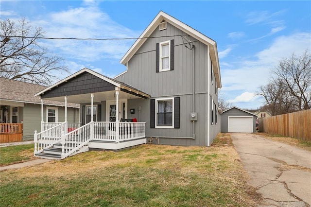 view of front of home featuring a front lawn, covered porch, an outdoor structure, and a garage