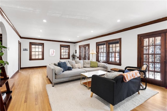 living room featuring ornamental molding and light hardwood / wood-style flooring