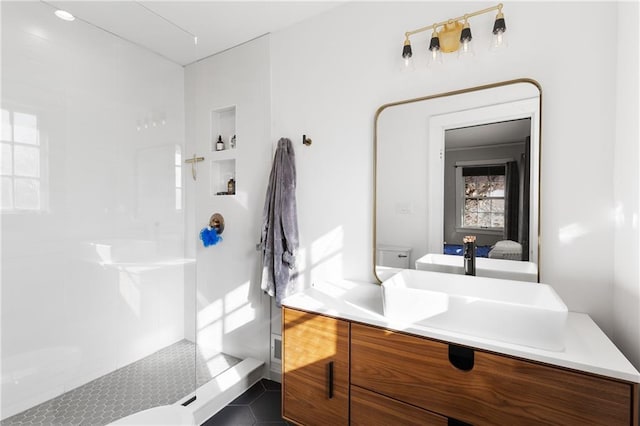 bathroom with vanity, a shower, and toilet