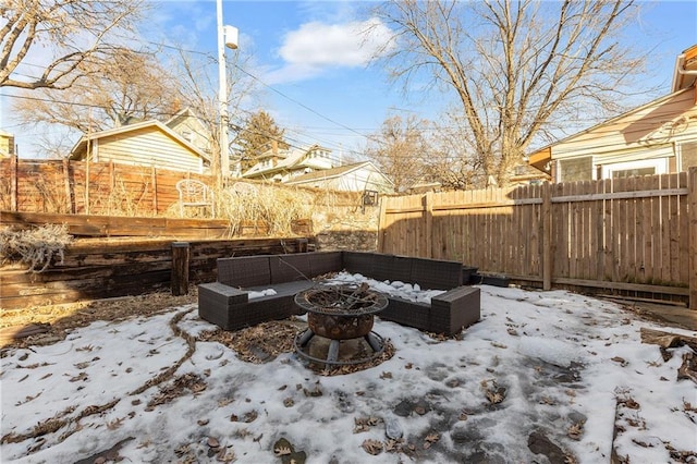 yard covered in snow featuring an outdoor fire pit