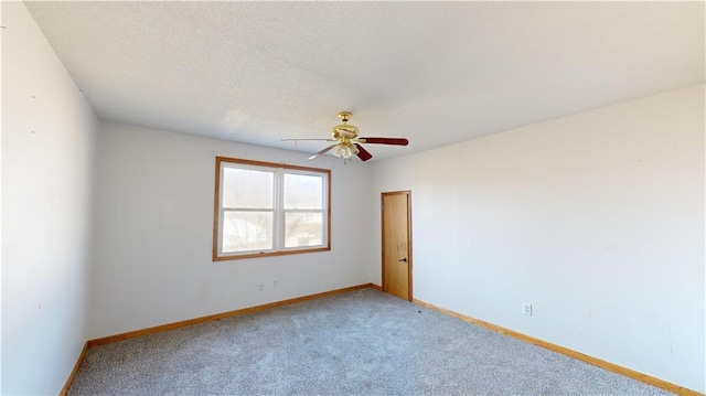 carpeted empty room with a textured ceiling and ceiling fan