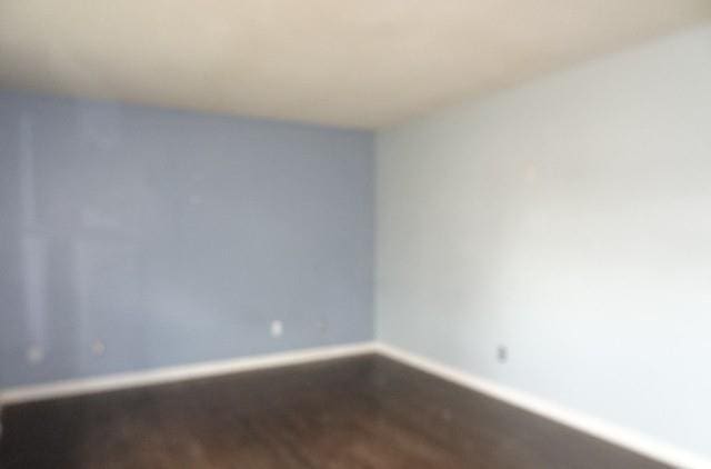 unfurnished room featuring wood-type flooring