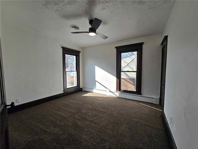 carpeted empty room with baseboard heating and ceiling fan