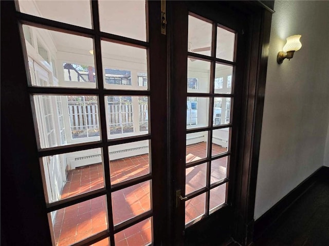 interior details with baseboard heating and french doors