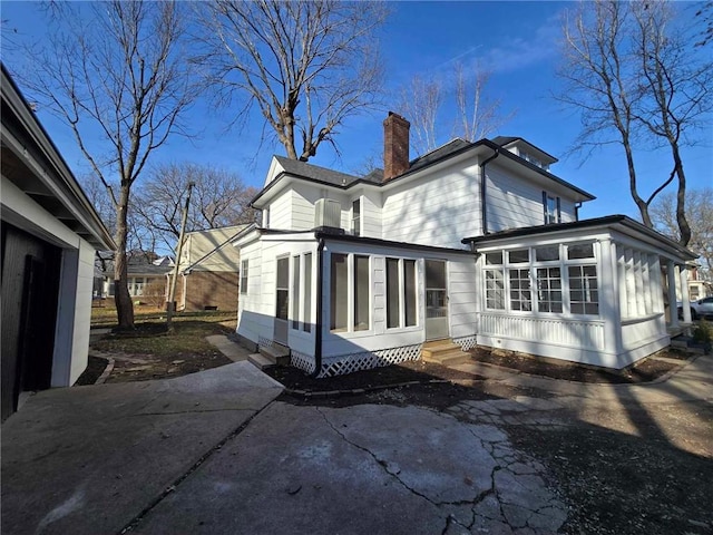 back of house featuring a sunroom