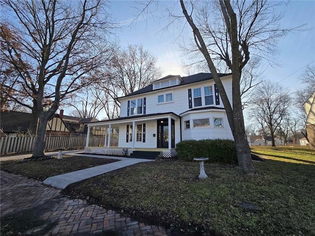 view of front of home with a front yard and a porch