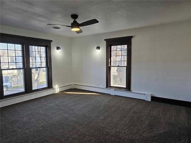 carpeted spare room with a textured ceiling and ceiling fan