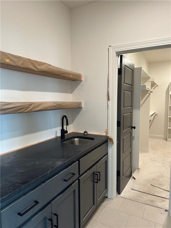 interior space featuring sink and light carpet