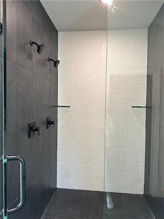 bathroom with tile patterned flooring and an enclosed shower