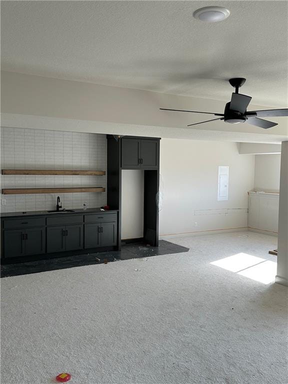 interior space featuring electric panel, ceiling fan, and sink