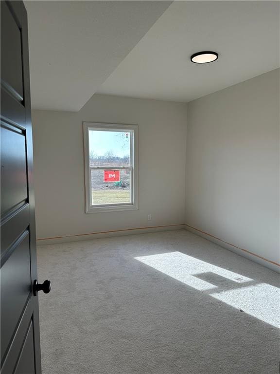 empty room featuring light carpet