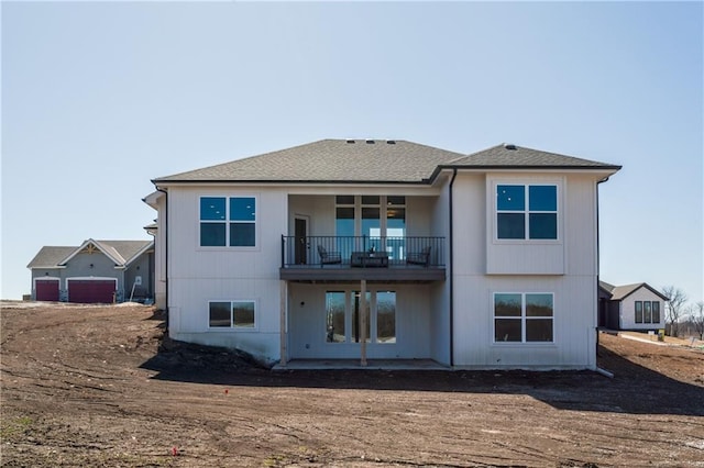 rear view of property with a balcony