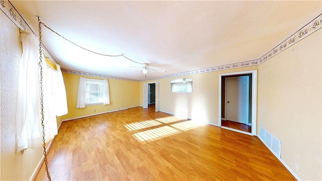 empty room featuring ceiling fan and wood-type flooring