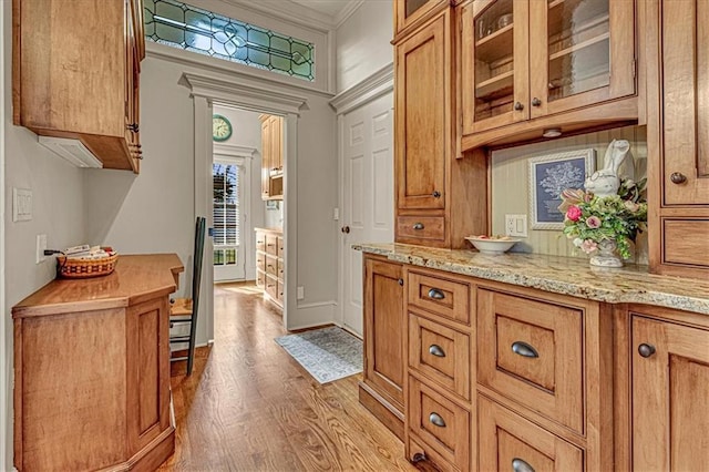 interior space with light hardwood / wood-style floors and crown molding