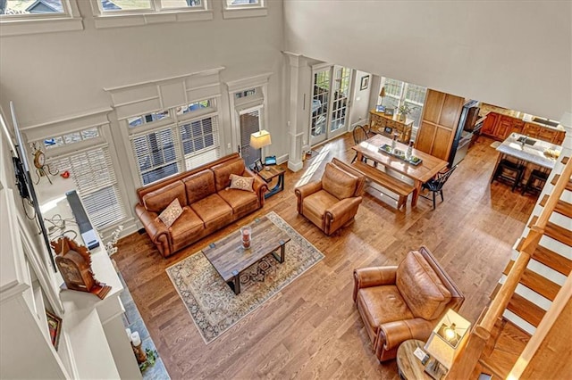 living room featuring hardwood / wood-style floors and a towering ceiling