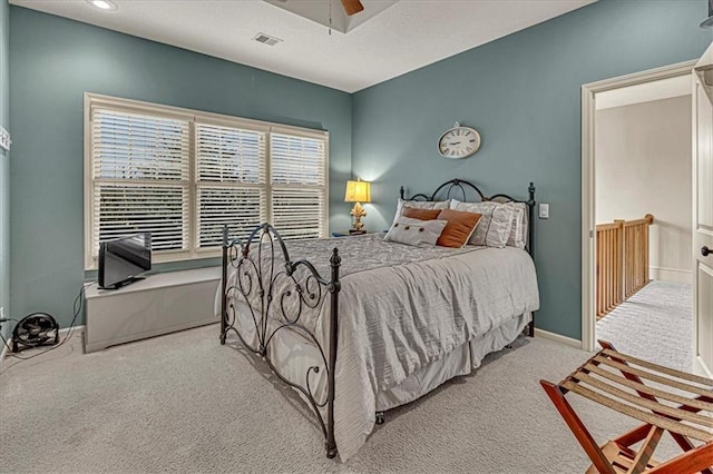 bedroom featuring light carpet and ceiling fan