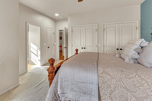 carpeted bedroom featuring two closets