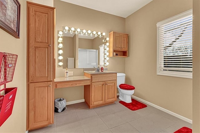 bathroom with tile patterned flooring, vanity, and toilet