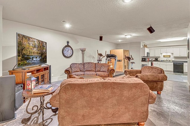 living room with sink, baseboard heating, and a textured ceiling