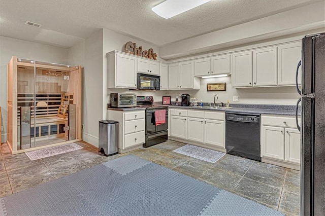 kitchen with black appliances, white cabinets, sink, and a textured ceiling