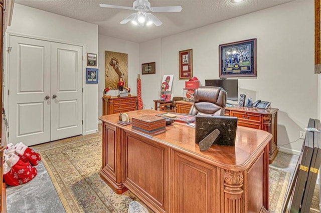 office space featuring ceiling fan and a textured ceiling