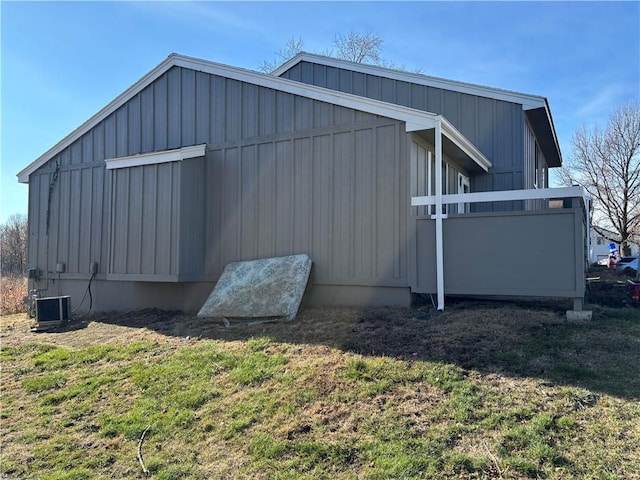 view of property exterior with a yard and central AC unit