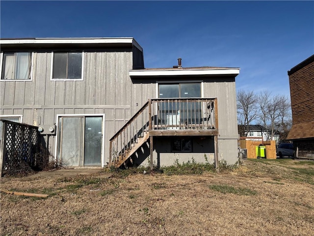 rear view of house featuring a yard and a deck