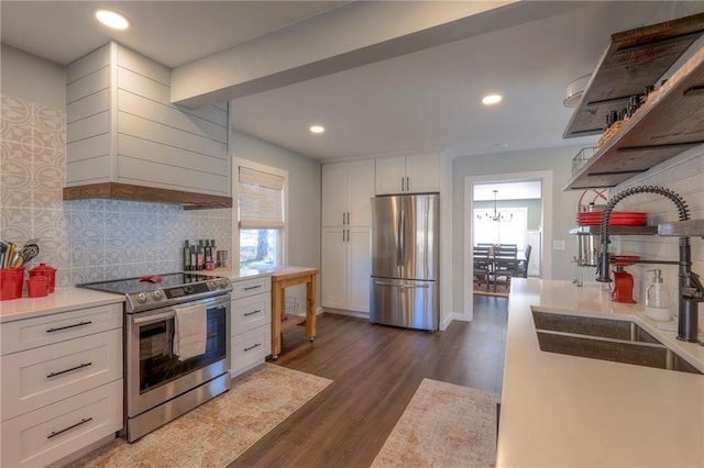 kitchen with appliances with stainless steel finishes, white cabinetry, a wealth of natural light, and sink