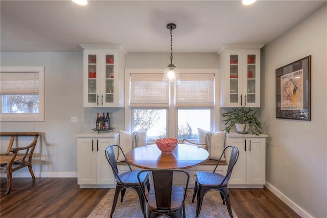 dining space with dark wood-type flooring