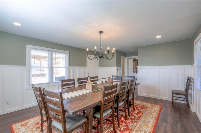 dining space featuring a chandelier and dark wood-type flooring