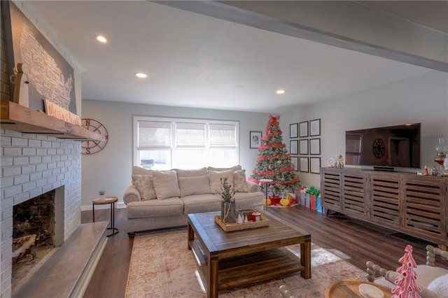 living room featuring a brick fireplace and light hardwood / wood-style flooring