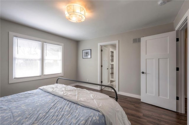 bedroom featuring dark wood-type flooring and multiple windows