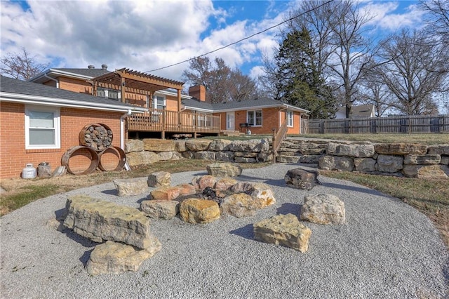 back of property featuring a pergola and a wooden deck