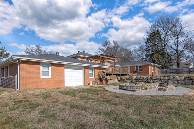 rear view of property featuring a lawn and a wooden deck