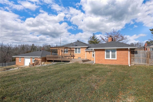 rear view of property with a lawn and a deck