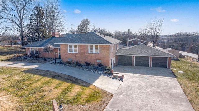 view of front of house featuring a garage, an outbuilding, and a front yard