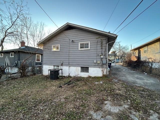 rear view of property with central AC unit