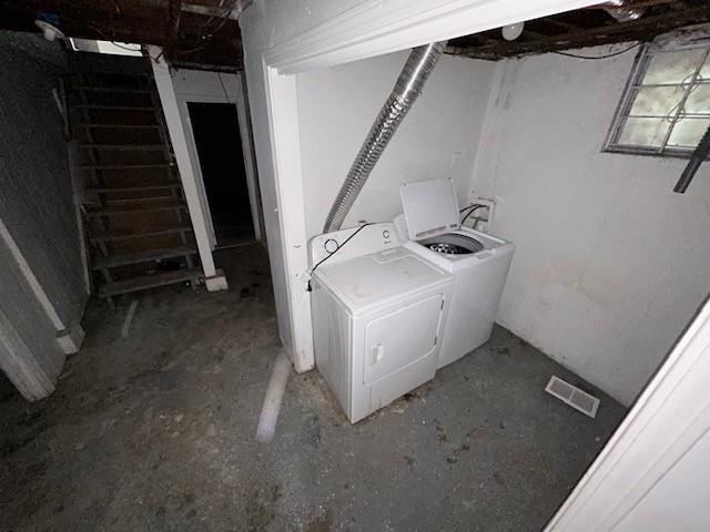 clothes washing area featuring washer and clothes dryer