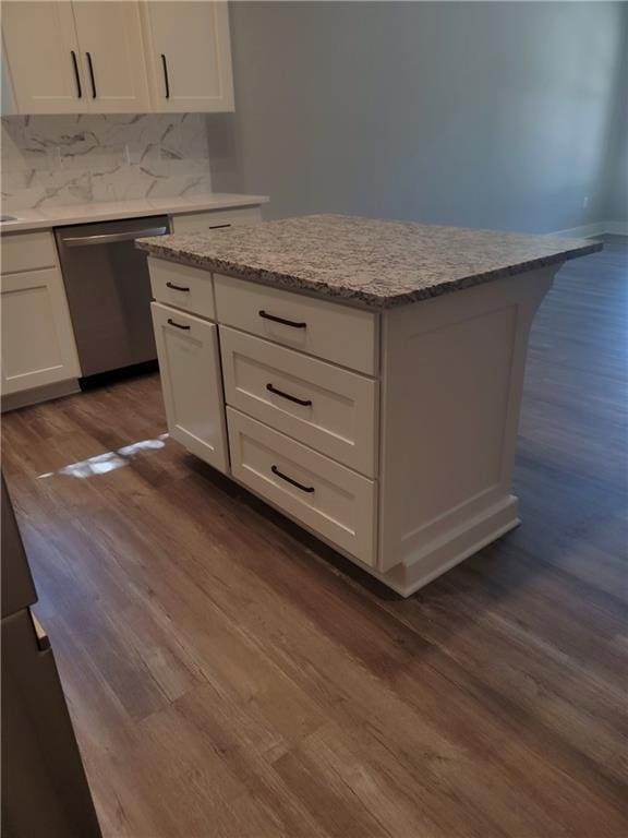 kitchen featuring dishwasher, backsplash, dark hardwood / wood-style floors, light stone counters, and white cabinetry