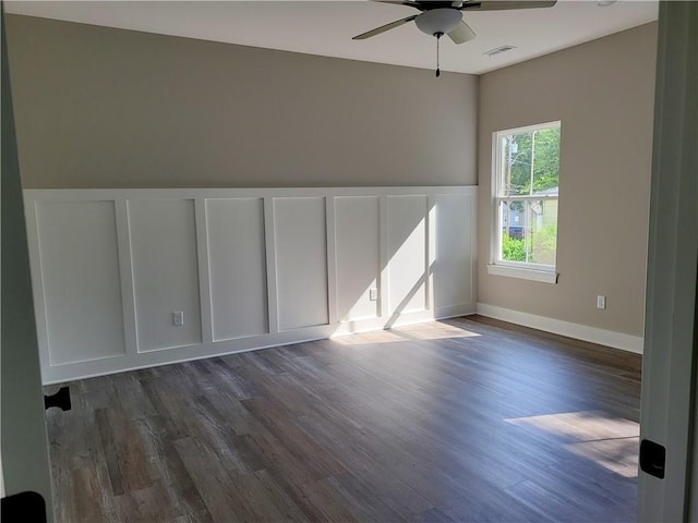 unfurnished room featuring ceiling fan and dark wood-type flooring