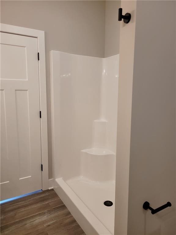 bathroom featuring hardwood / wood-style flooring and a shower