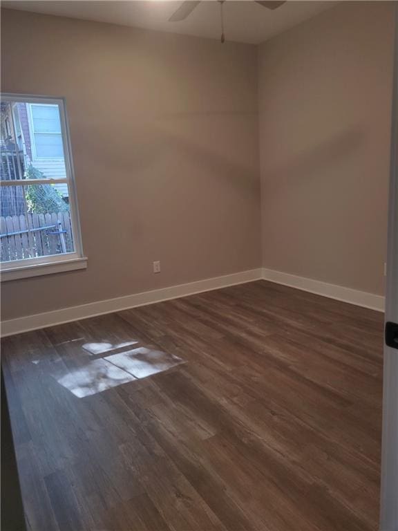 unfurnished room featuring dark hardwood / wood-style floors and ceiling fan