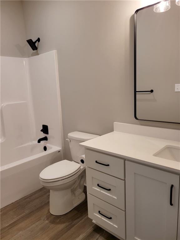 full bathroom featuring wood-type flooring, vanity, toilet, and tub / shower combination