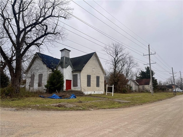 view of home's exterior with crawl space, a chimney, and entry steps